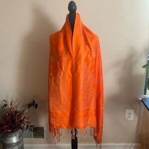 Pashmina wrap orange with gold print designs. Fringe trim NWOT